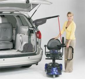 Woman using vehicle lift for mobility scooter