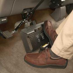 Driver's foot using car pedal adapter