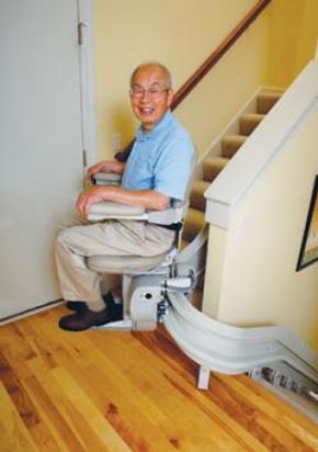 Elderly person using stairlift at home