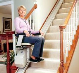 Person riding stairlift in a home