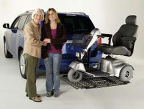 Mobility scooter on car lift platform.