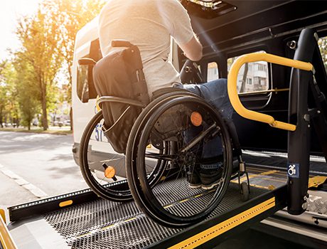 Man boarding vehicle with wheelchair assistance