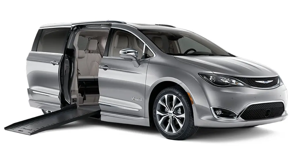 Silver minivan with sliding door open and spacious interior visible.