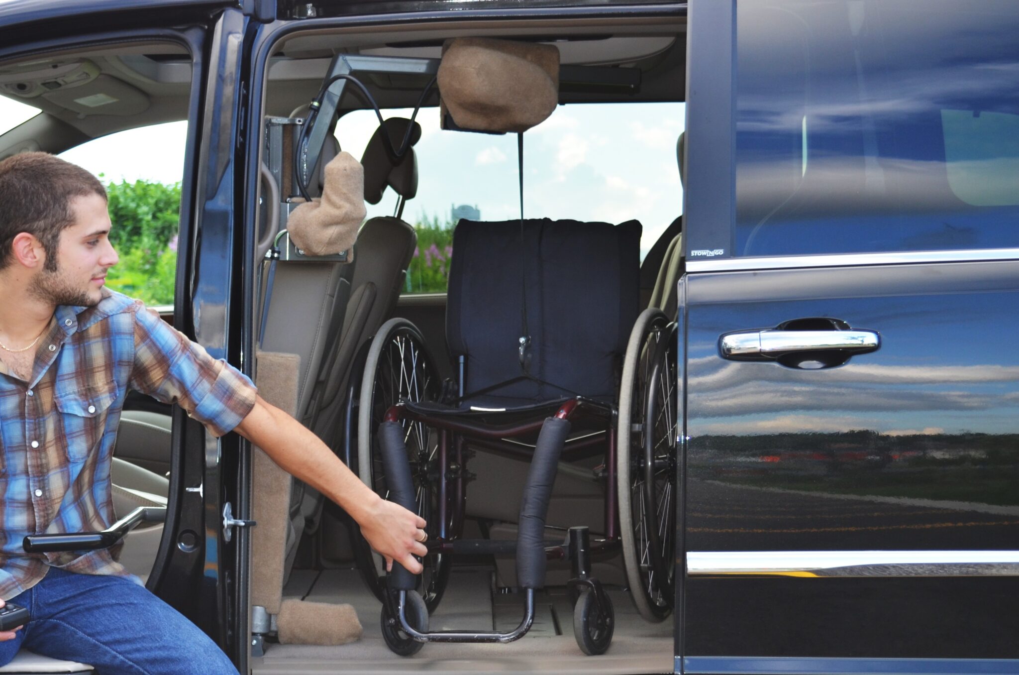 Wheelchair accessible van with door open showing interior space.
